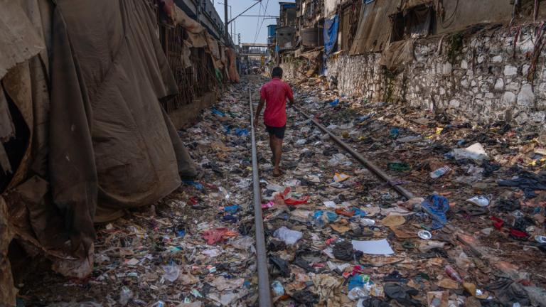 FILE - A man walks on a railway track littered with plastic and other waste materials on Earth Day in Mumbai, India, April 22, 2024. (Rafiq Maqbool / AP Photo, File)