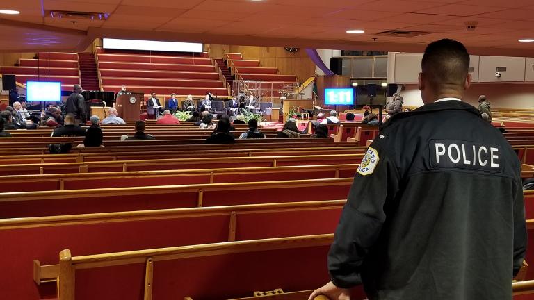 A Chicago police officer looks on during Monday’s police board listening session at the Trinity United Church of Christ. (Matt Masterson / WTTW News)