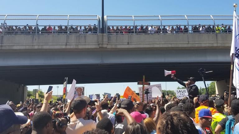 Protesters pause at the 76th Street overpass on the Dan Ryan Expressway on July 7, 2018. (Matt Masterson / Chicago Tonight)