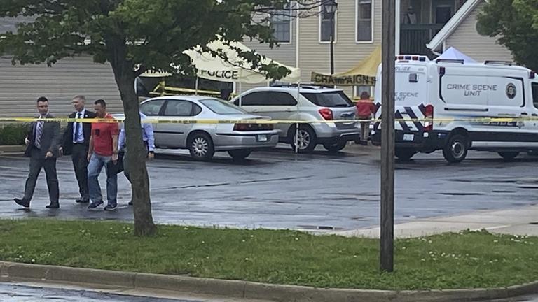 Police investigators work at the scene of a shooting in Champaign, Ill., Wednesday, May 19, 2021. (Jim Rossow / The News-Gazette via AP)