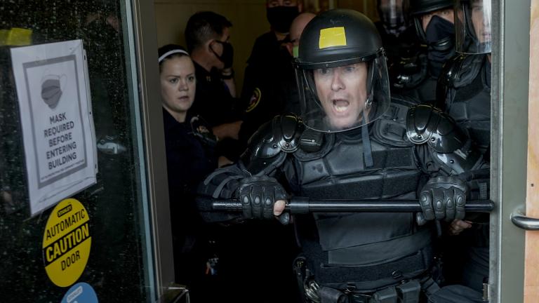 Police try to secure the public safety building from protesters Monday, Aug. 24, 2020, in Kenosha, Wis. (AP Photo / Morry Gash)