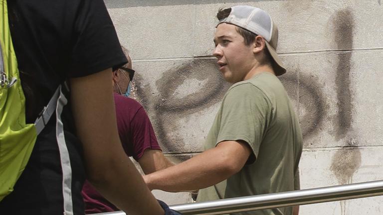 Kyle Rittenhouse helps clean the exterior of Reuther Central High School in Kenosha, Wis., on Tuesday, Aug. 25, 2020. Rittenhouse, 17, was arrested Wednesday, Aug. 26, after two people were shot to death during protests in Kenosha over the police shooting of Jacob Blake. (Pat Nabong / Chicago Sun-Times via AP)