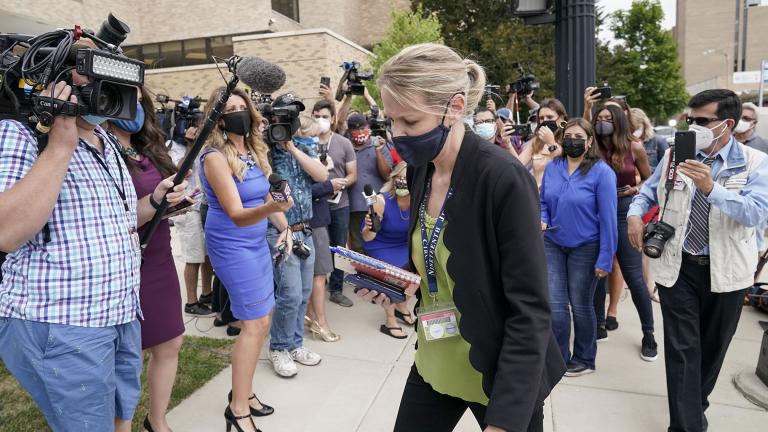 Kasey Morgan, a public information officer for the Lake County Court, walks away from reporters outside the Lake County courthouse following the extradition hearing for Kyle Rittenhouse Friday, Aug. 28, 2020, in Waukegan, Ill.(AP Photo / Morry Gash)