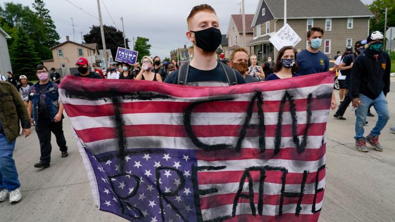 A protester holds a flag during a Black Lives Matter protest Tuesday, Sept. 1, 2020, in Kenosha, Wis. (AP Photo / Morry Gash) A protester holds a flag during a Black Lives Matter protest Tuesday, Sept. 1, 2020, in Kenosha, Wis. (AP Photo / Morry Gash)