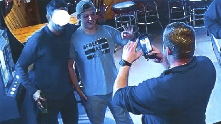 In this image from video provided by the Kenosha County District Attorney, Kyle Rittenhouse poses for a photo at Pudgy's Pub in Mount Pleasant, Wis., on Jan. 5, 2021, the day he was arraigned on charges related to the killing of two people at an August protest in Kenosha. (Courtesy of Kenosha County District Attorney via AP)