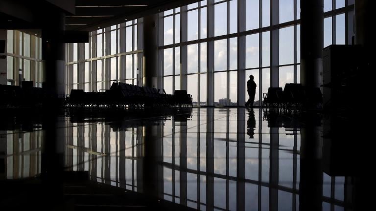 In this June 1, 2020 file photo, a woman looks through a window at a near-empty terminal at an airport in Atlanta. The coronavirus pandemic has taken a harsh toll on the mental health of young Americans, according to a new poll. (AP Photo/Charlie Riedel, File) In this June 1, 2020 file photo, a woman looks through a window at a near-empty terminal at an airport in Atlanta. The coronavirus pandemic has taken a harsh toll on the mental health of young Americans, according to a new poll. (AP Photo/Charlie Riedel, File)