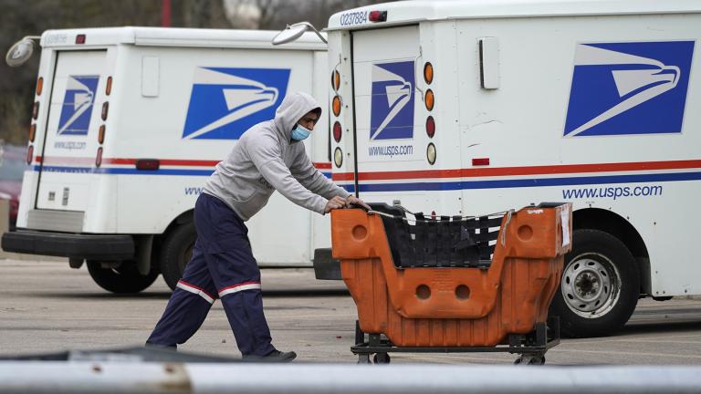 A United States Postal Service employee works outside a post office in Wheeling, Ill., Dec. 3, 2021. (AP Photo / Nam Y. Huh, File)