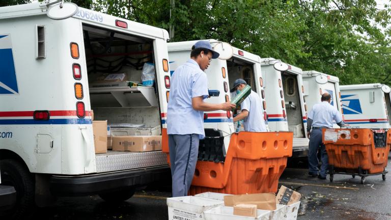 In this July 31, 2020, file photo, letter carriers load mail trucks for deliveries at a U.S. Postal Service facility in McLean, Va. (AP Photo / J. Scott Applewhite, File)