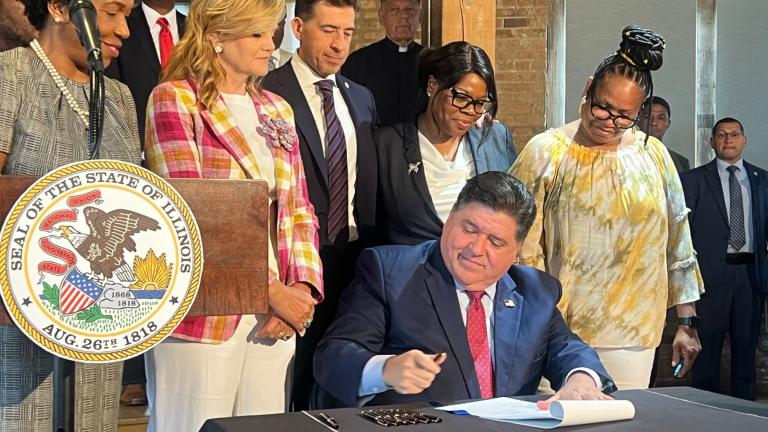 Gov. J.B. Pritzker signs a bill on Aug. 6, 2024, aimed at making it easier for formerly incarcerated people to get IDs. (Amanda Vinicky / WTTW News)