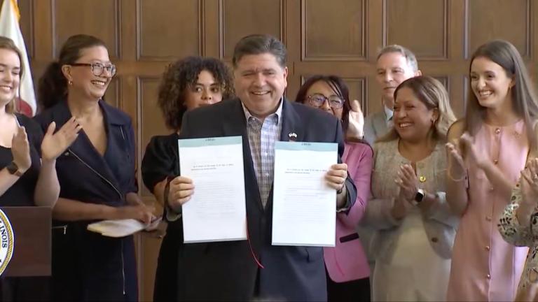Gov. JB Pritzker signs bills aimed at further protecting reproductive rights in Illinois on Aug. 22, 2025, at the University YMCA in Champaign, Illinois. (Courtesy of state of Illinois live stream)