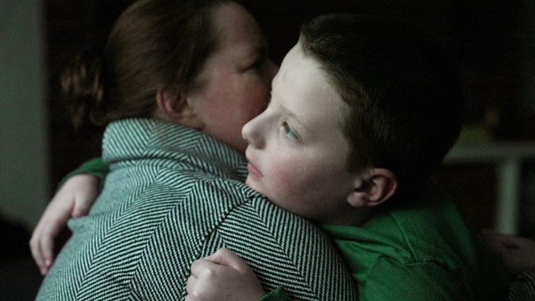 Ronan Murphy hugs his mother, Andrea, while looking at the snow falling outside their home in Ayer, Mass., on Saturday, Jan. 17, 2026. (AP Photo / Shelby Lum)