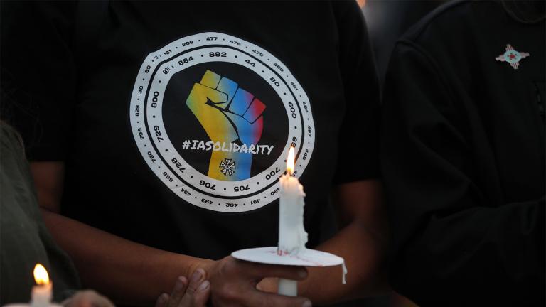 Movie industry worker Hailey Josselyn, wearing a t-shirt of the International Alliance of Theatrical Stage Employees (IATSA), holds a candle during a vigil to honor cinematographer Halyna Hutchins in Albuquerque, N.M., Saturday, Oct. 23, 2021. Hutchins was killed when actor Alec Baldwin fired a weapon on a film set that a crew member told him was safe. The tragedy has led to calls for fundamental change in Hollywood: the banning of real guns on sets. (AP Photo / Andres Leighton, file)