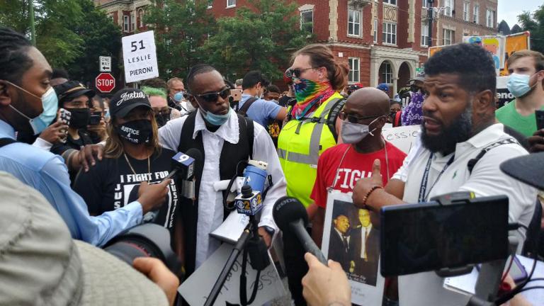 Members of the Chicago Activist Coalition for Justice, led by Rabbi Michael Ben Yosef (center, in white shirt with black vest), speak with the media at a protest against police brutality on Saturday, Aug. 15, 2020 in Chicago. (Annemarie Mannion / WTTW News)