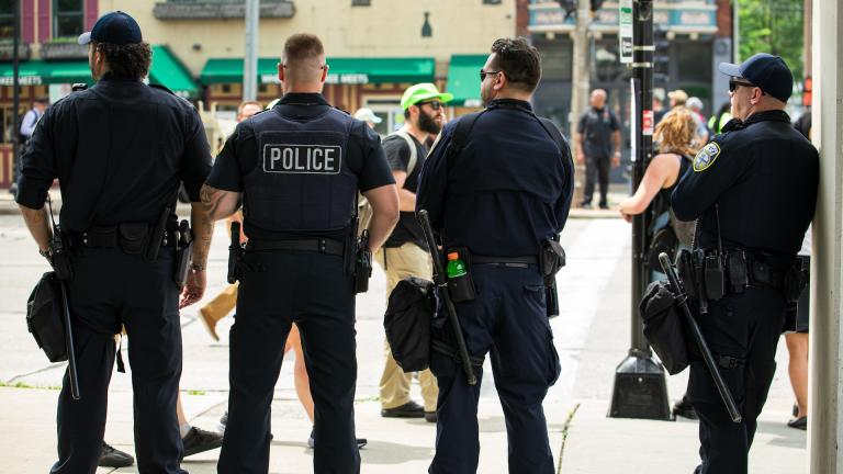 Police officers stand watch during a protest march through Milwaukee during the Republican National Convention on July 15, 2024. (Michael Izquierdo / WTTW News)