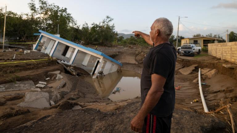 A man points to a home that was collapsed by Hurricane Fiona at Villa Esperanza in Salinas, Puerto Rico, Wednesday, September 21, 2022. (AP Photo  /Alejandro Granadillo)