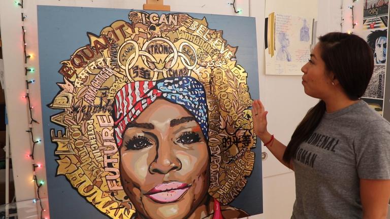 Artist Anna Dominguez, the self-described “Queen of Tape,” stands before a portrait of tennis player Serena Williams. She made the work of art using thousands of pieces of tape. (Evan Garcia / WTTW News)