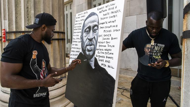 Artist Dennis Owes, 31, from Ghana gives the last touch to his portrait of George Floyd during a rally on Sunday, May 23, 2021, in Brooklyn borough of New York. (AP Photo / Eduardo Munoz Alvarez)