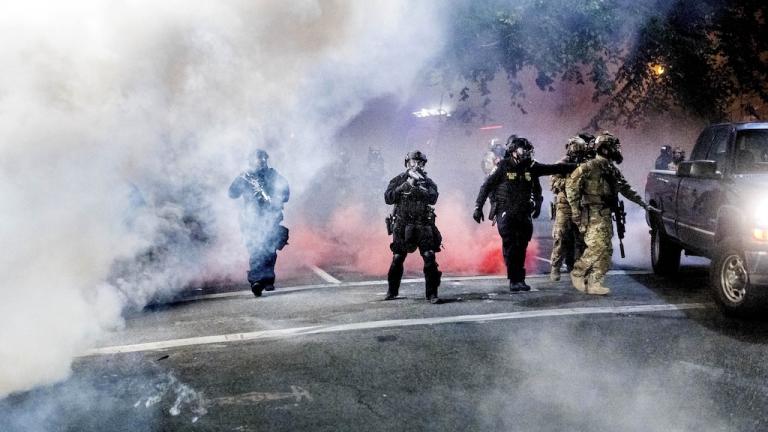 Federal officers use crowd control munitions to disperse Black Lives Matter protesters outside the Mark O. Hatfield United States Courthouse on Tuesday, July 21, 2020, in Portland, Ore. (AP Photo/Noah Berger)