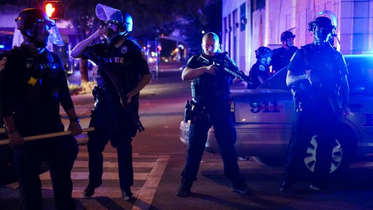 Police stand guard on the perimeter of a crime scene after a police officer was shot, Wednesday, Sept. 23, 2020, in Louisville, Ky. (AP Photo / John Minchillo, File)
