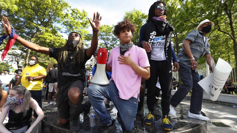 In this June 3, 2020 file photo, Stefan Perez, second from left, addresses a crowd at a rally in Detroit over the death of George Floyd. (AP Photo / Paul Sancya)