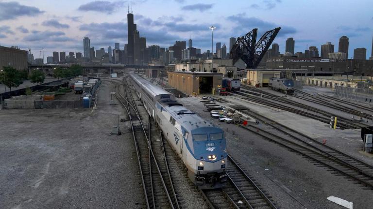 An Amtrak passenger train departs Chicago in the early evening headed south on Sept. 14, 2022, in Chicago. American consumers and nearly every industry will be affected if freight trains grind to a halt in December. Roughly half of all commuter rail systems rely at least in part on tracks that are owned by freight railroads, and nearly all of Amtrak’s long-distance trains run over the freight network. (AP Photo/Charles Rex Arbogast, File)