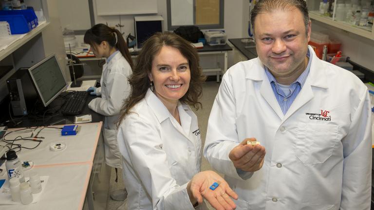 UIC bioengineering professor Ian Papautsky and Erin Haynes of the University of Cincinnati Department of Environmental Health present a sensor that will conduct rapid testing for human exposure to toxic metals. (Courtesy University of Cincinnati)