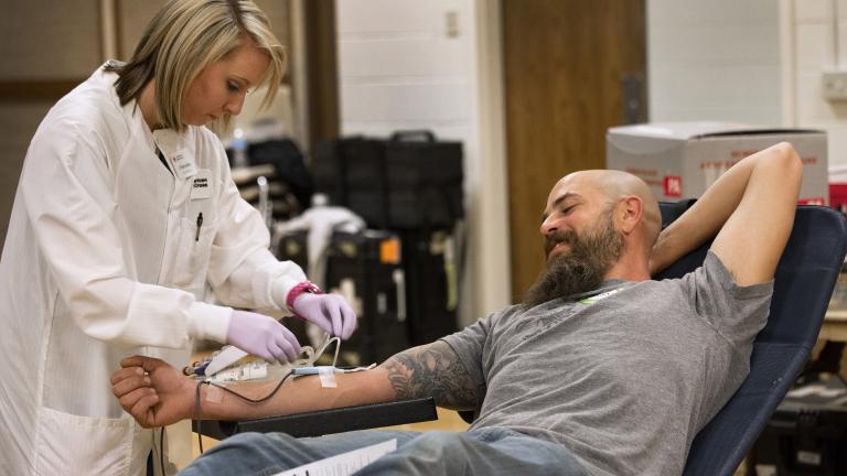 American Red Cross collections staff member Cherrelle Simon collects a blood donation from Clint Kraft.  (Amanda Romney / American Red Cross) 