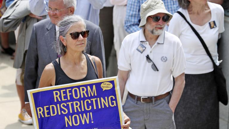 People listen to speakers during the Redistricting Reform Rally at the Indiana Statehouse in Indianapolis, Aug. 11, 2021. (Kelly Wilkinson / The Indianapolis Star via AP, File)