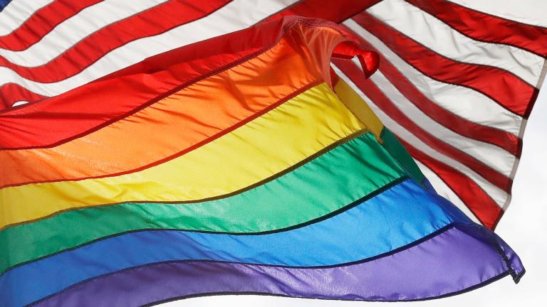 FILE - The LGBTQ+ pride flag flies beneath the American flag at the Stonewall National Monument, Oct. 11, 2017, in New York. (Mark Lennihan / AP Photo, File)