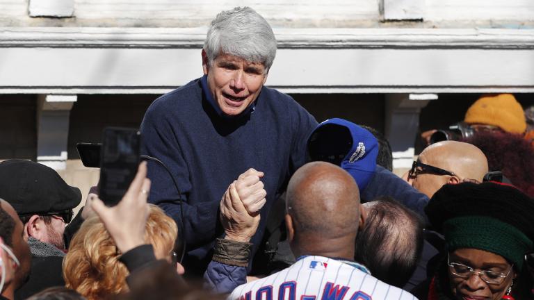 Former Illinois Gov. Rod Blagojevich acknowledges Chicago Cubs’ fan Ronnie Woo Woo after a news conference outside his home Wednesday, Feb. 19, 2020, in Chicago. (AP Photo / Charles Rex Arbogast)