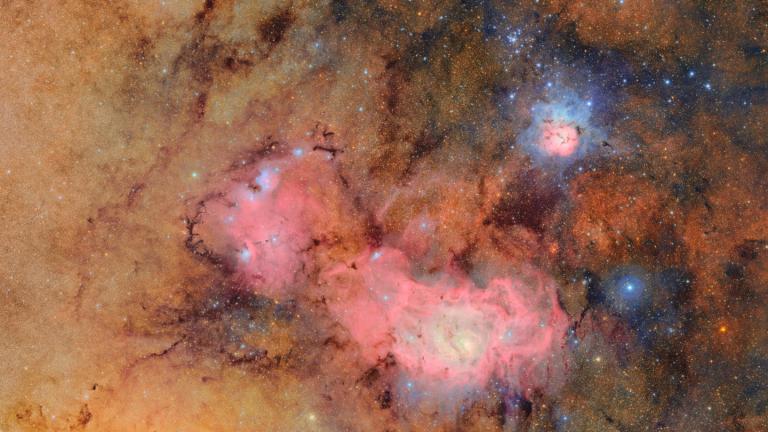 This image provided by the NSF-DOE Vera C. Rubin Observatory shows 678 separate images taken by the observatory in just over seven hours of observing time. Combining many images in this way clearly reveals otherwise faint or invisible details, such as the clouds of gas and dust that comprise the Trifid nebula (top right) and the Lagoon nebula, which are several thousand light-years away from Earth. (NSF-DOE Vera C. Rubin Observatory via AP)