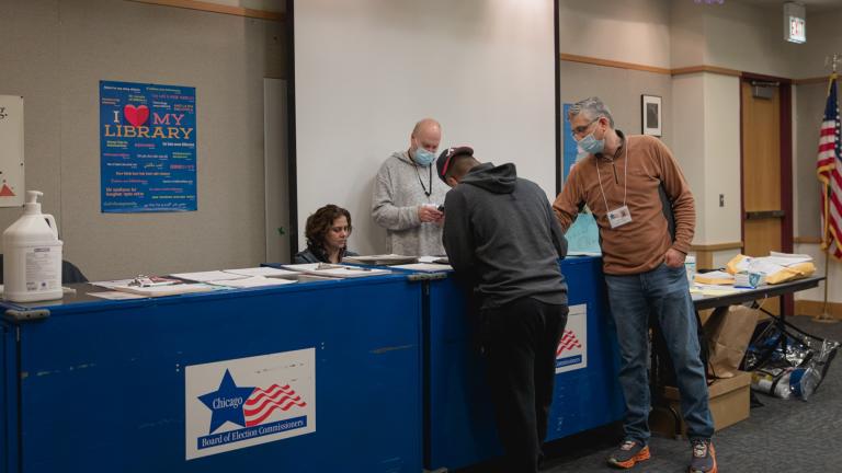 A resident in the 40th Ward gathers their documentation as they prepare to vote in the April 4 Chicago runoff election at the Budlong Woods Library polling location. (Michael Izquierdo / WTTW News)