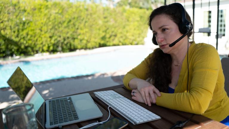 Julia Entin sits at her computer at her backyard office, coordinating efforts to rescue Holocaust survivors in Ukraine, Monday, March 14, 2022, in Los Angeles. (AP Photo / Richard Vogel)