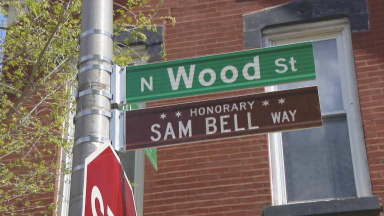 An honorary street sign for Sam Bell is unveiled May 5, 2023, at Wood and Rice streets in West Town. (WTTW News)