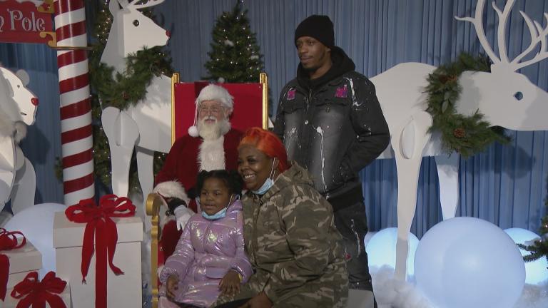 Santa Claus takes pictures with visitors at the Lincoln Park Zoo on Tuesday, Dec. 14, 2021. (WTTW News)