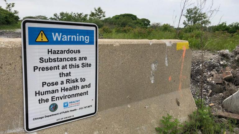 A Chicago Department of Public Health sign warns passersby about hazardous materials at a 67-acre property west of Wolf Lake at 126th Place and Avenue O. (Alex Ruppenthal / WTTW News)