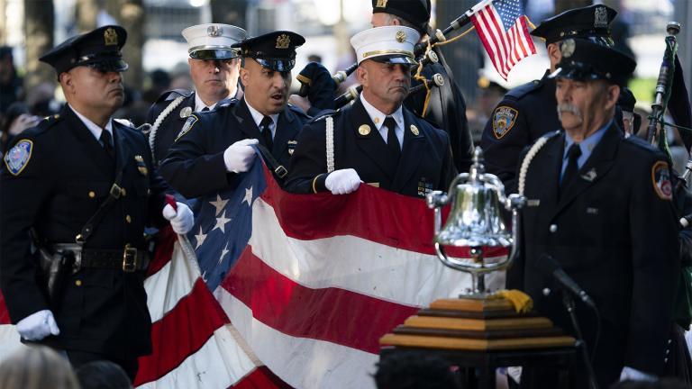 A memorial flag is brought onto the stage during ceremonies to commemorate the 20th anniversary of the Sept. 11 terrorist attacks, Saturday, Sept. 11, 2021, at the National September 11 Memorial & Museum in New York. (AP Photo/John Minchillo)