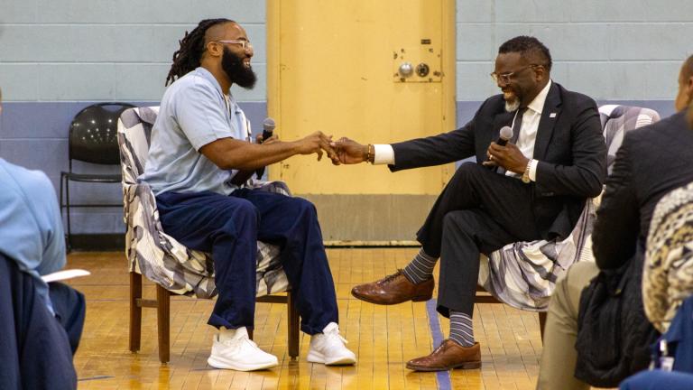 Incarcerated Northwestern University student André Patterson shakes hands with Chicago Mayor Brandon Johnson during his visit to Sheridan Correctional Center on  Sunday, March 15, 2026. (Blair Paddock / WTTW News)