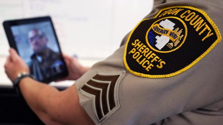 In this Friday, Aug. 13, 2021, photo Sheriff’s Police Sgt. Bonnie Busching tests a virtual meeting with a tablet at the Cook County Sheriff’s Office in Chicago. (AP Photo / Nam Y. Huh)