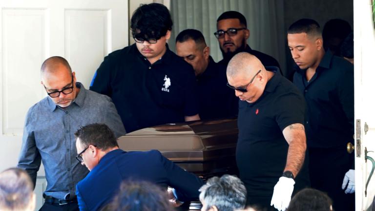 Pallbearers carry the body of Eduardo Uvaldo, who was killed Monday during a mass shooting at the Fourth of July parade in Highland Park, Ill., from the Memorial Chapel funeral home after visitation and a service Saturday, July 9, 2022, in Waukegan, Ill. (AP Photo/  Charles Rex Arbogast)