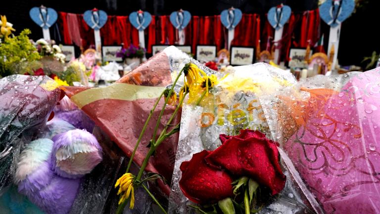 Wet flowers are seen during a rainy day at a memorial to the seven people killed and others injured in the Fourth of July mass shooting at the Highland Park War Memorial, Friday, July 15, 2022, in Highland Park, Ill. (AP Photo / Nam Y. Huh)