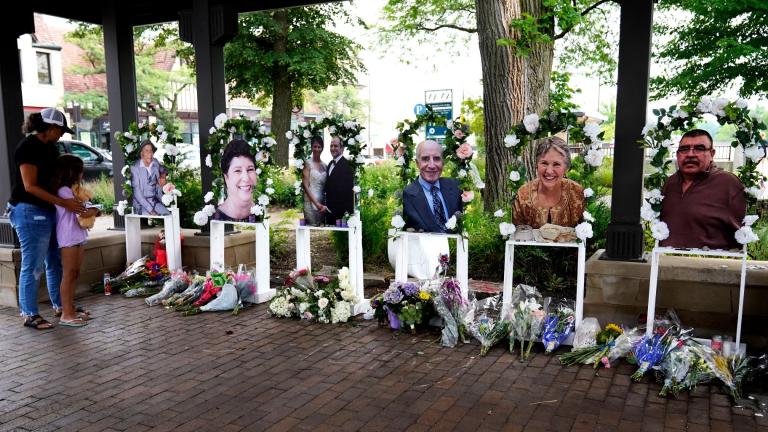 Visitors pay their respects, Thursday, July 7, 2022, at altars for the seven people killed in the Fourth of July mass shooting in Highland Park, Ill. (AP Photo / Nam Y. Huh, File)