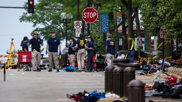 Local, state and federal police work the scene of a mass shooting at a Fourth of July parade in Highland Park, Ill., Monday, July 4, 2022. (Tyler Pasciak LaRiviere / Chicago Sun-Times via AP, File)