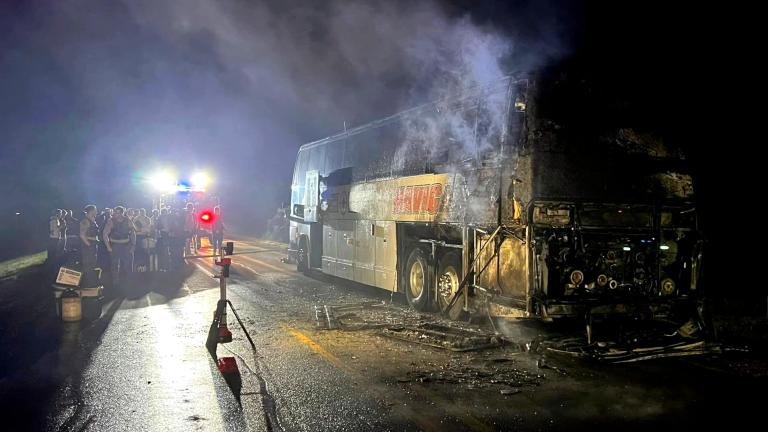 In this photo provided by J.D. Scholten, a bus carrying the Sioux City Explorers to a baseball game in Illinois caught fire early on Friday, Aug. 2, 2024, near Earlham, Iowa. State Rep. J.D. Scholten, who is a pitcher for the team, wrote in a Facebook post that he was grateful no one was hurt. (J.D. Scholten via AP)