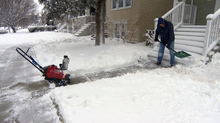 A man shovels snow after a storm in Chicago in February 2021. More snow is expected in the area on Valentine’s Day, along with subzero wind chills, according to the National Weather Service. (WTTW News) A man shovels snow after a storm in Chicago in February 2021. More snow is expected in the area on Valentine’s Day, along with subzero wind chills, according to the National Weather Service. (WTTW News)