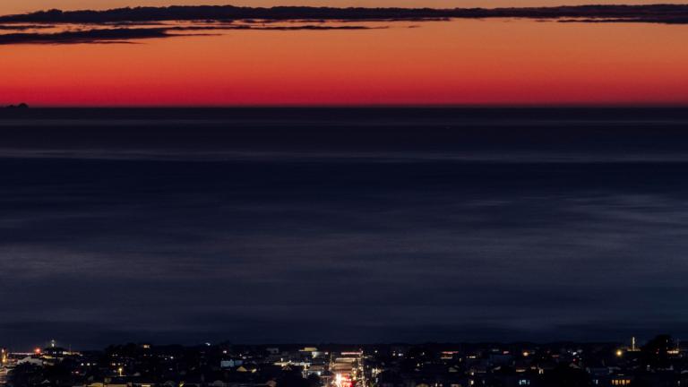 FILE - Vehicles travel along a street at sunset on the winter solstice in San Francisco, Thursday, Dec. 21, 2023. (Stephen Lam / San Francisco Chronicle via AP, File)