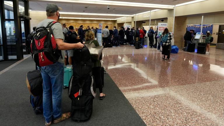 Passengers queue up at the ticketing counter for Southwest Airlines flights in Eppley Airfield Sunday, Oct. 10, 2021, in Omaha, Nebraska. Southwest Airlines canceled hundreds of flights over the weekend, blaming the woes on air traffic control issues and weather. (AP Photo / David Zalubowski)