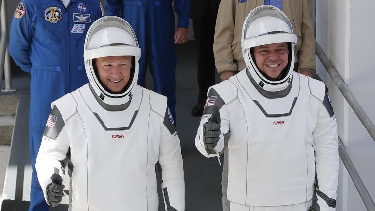 In this May, 30, 2020 file photo, NASA astronauts Douglas Hurley, left, and Robert Behnken walk out of the Neil A. Armstrong Operations and Checkout Building on their way to Pad 39-A, at the Kennedy Space Center in Cape Canaveral, Fla. (AP Photo / John Raoux, File)