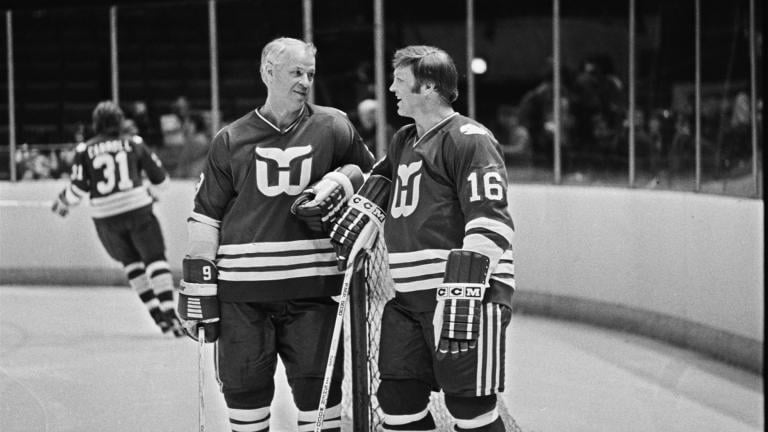 Hartford Whalers' star Gordie Howe, left, and Bobby Hull, right, have a chat as Hartford Whalers practice before their NHL game with the Washington Capitals, March 8, 1980. (AP Photo/William Smith, File)