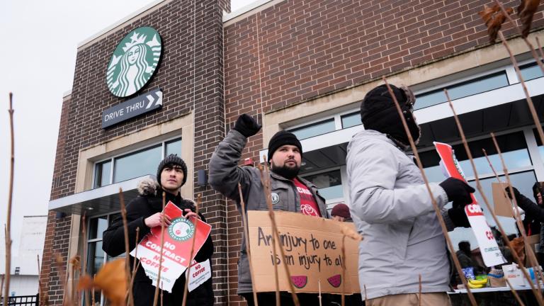 Employees picket outside a Starbucks store, Friday, Dec 20, 2024, in Chicago. (AP Photo / Kiichiro Sato)